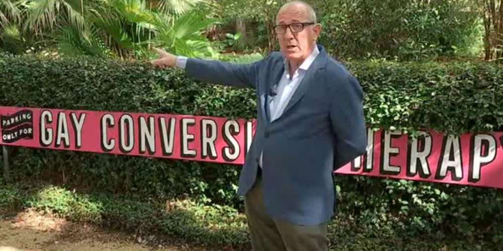 Gallery Owner Puts Up ‘Gay Conversion Therapy’ Sign to Shade Church That Keeps Stealing His Parking Spots